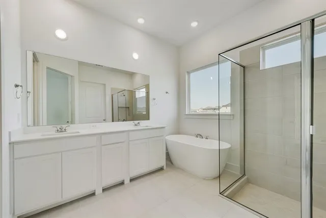 a bathroom with a bathtub and shower