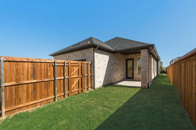 a living room with a couch and a view of kitchen