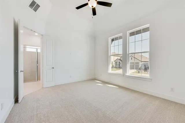 a view of a kitchen with refrigerator and windows