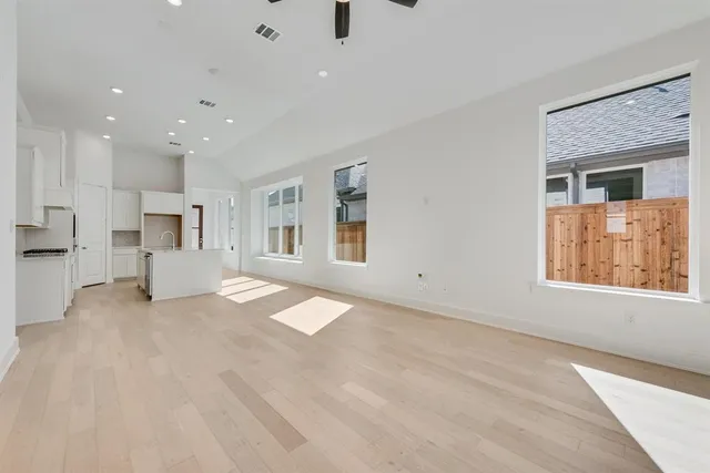 a view of a living room a refrigerator and windows