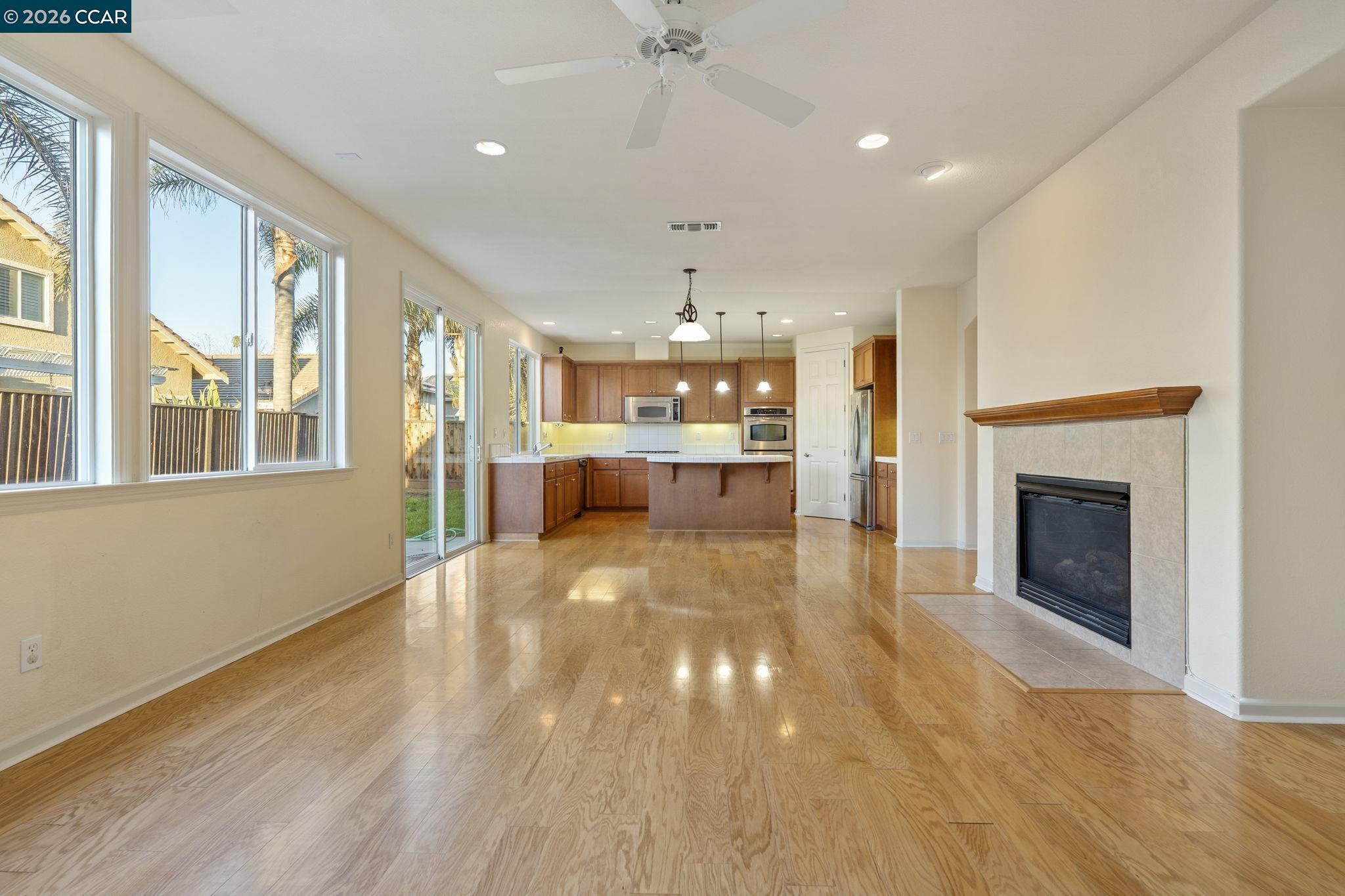 5141 Fern Ridge Circle Discovery Bay, CA 94505 - Photo 13 of 56 a view of an empty room with a kitchen and fireplace