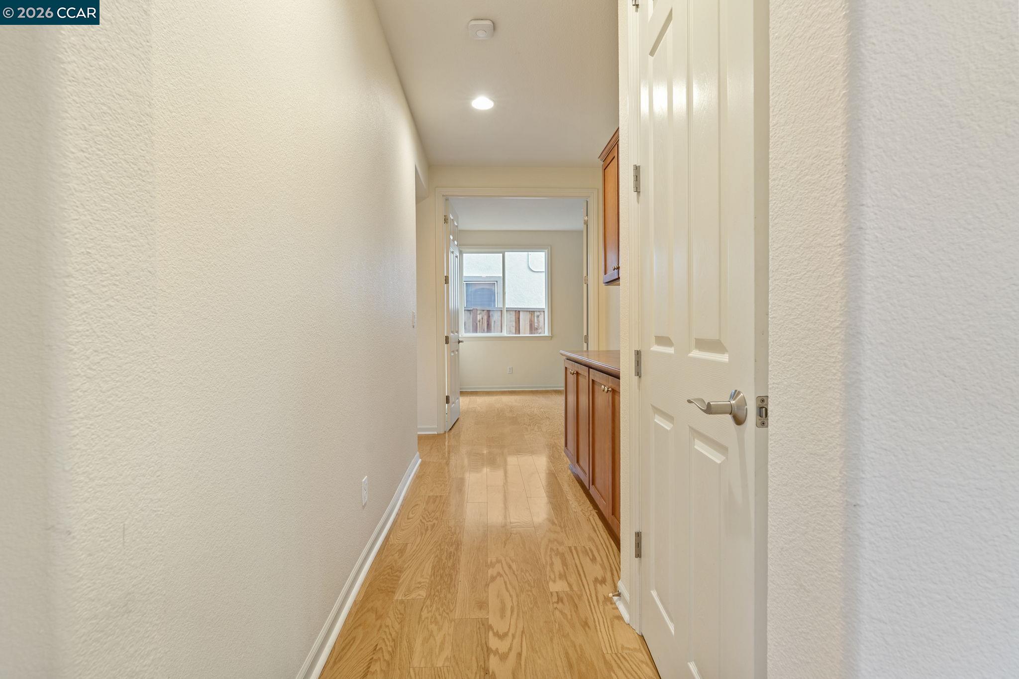 5141 Fern Ridge Circle Discovery Bay, CA 94505 - Photo 16 of 56 a view of a hallway with wooden floor and a bathroom