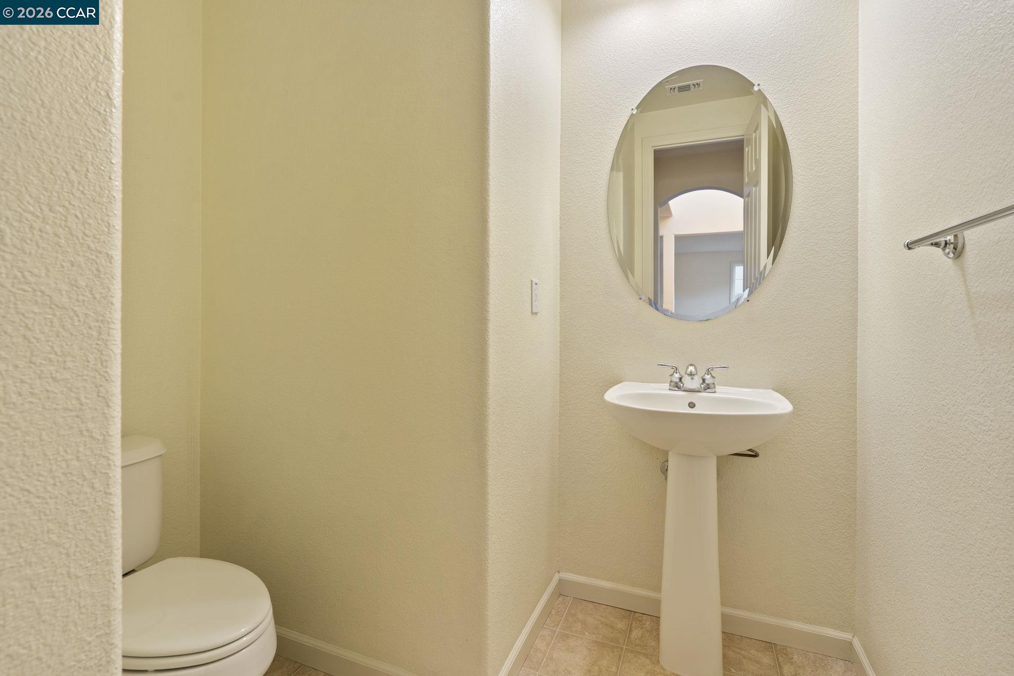 5141 Fern Ridge Circle Discovery Bay, CA 94505 - Photo 17 of 56 a bathroom with a sink a toilet and a mirror