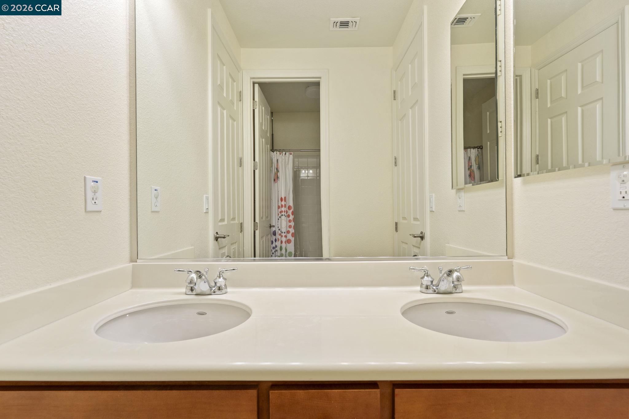 5141 Fern Ridge Circle Discovery Bay, CA 94505 - Photo 28 of 56 a bathroom with double vanity sinks and a mirror