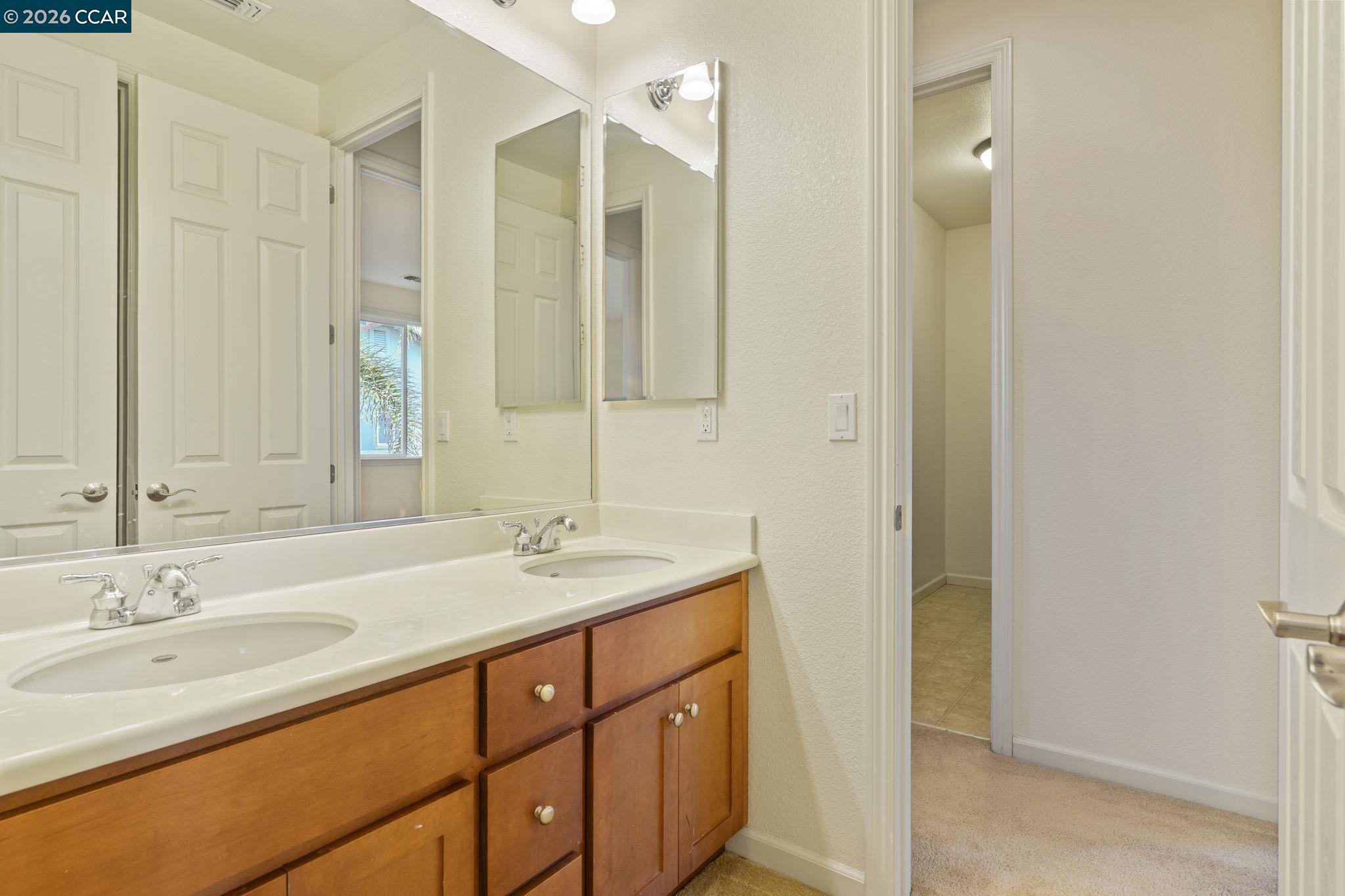 5141 Fern Ridge Circle Discovery Bay, CA 94505 - Photo 30 of 56 a bathroom with a granite countertop sink and a mirror