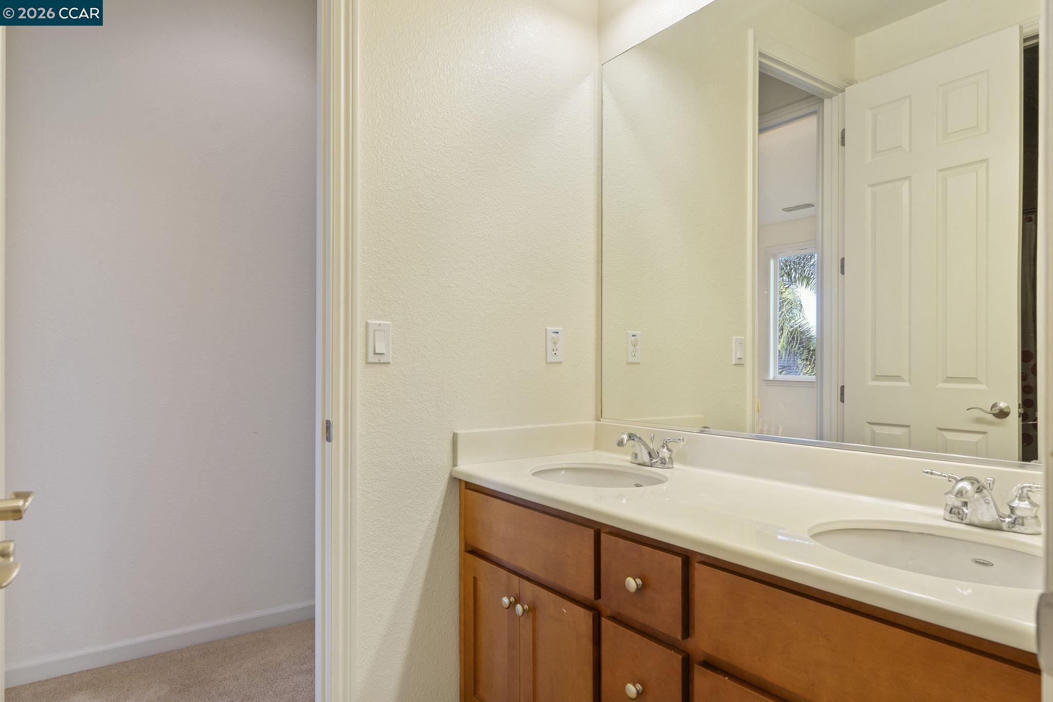 5141 Fern Ridge Circle Discovery Bay, CA 94505 - Photo 33 of 56 a bathroom with a granite countertop sink and a mirror