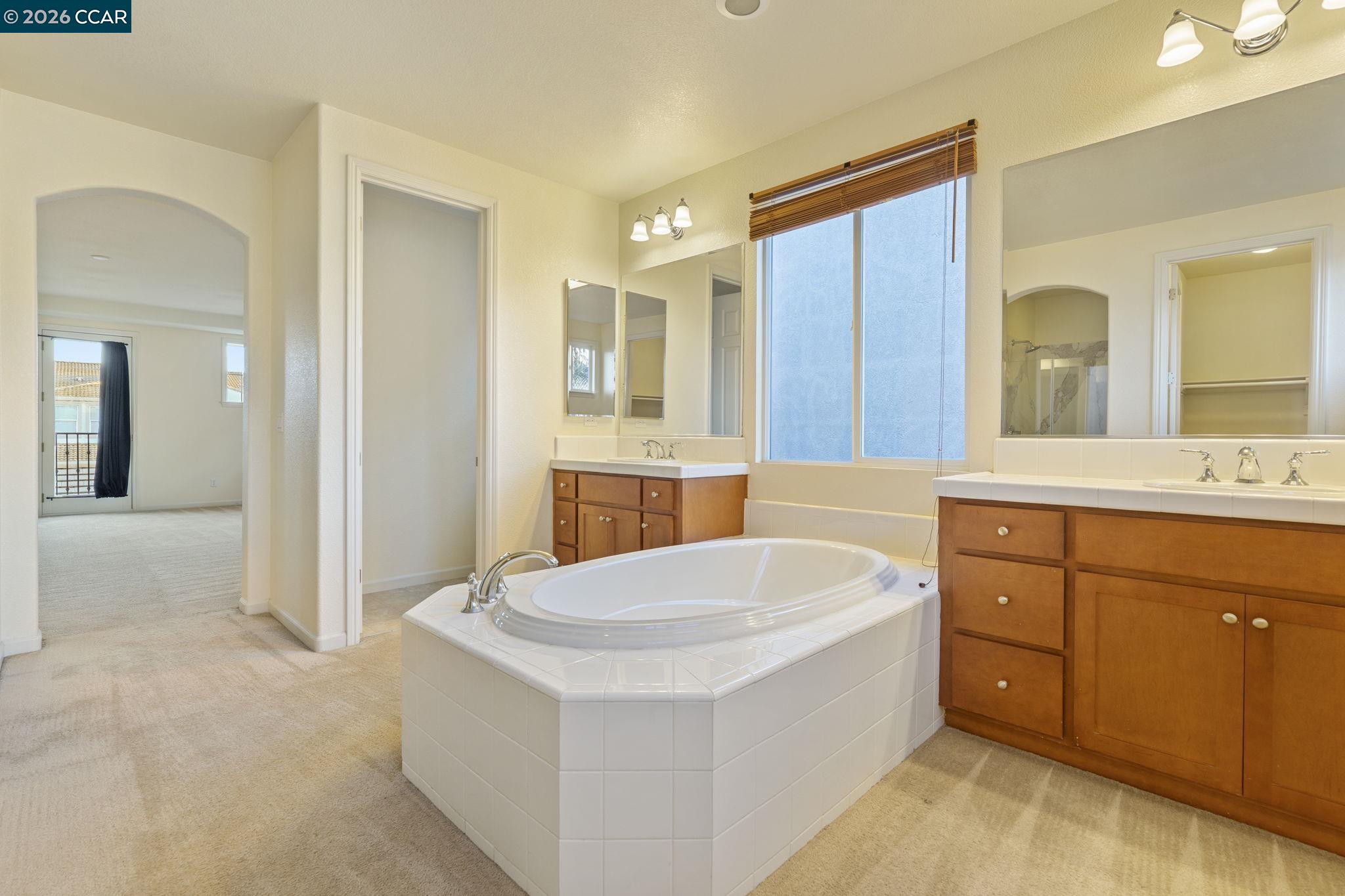 5141 Fern Ridge Circle Discovery Bay, CA 94505 - Photo 43 of 56 a spacious bathroom with a tub sink and mirror