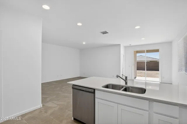 a kitchen with a sink and white cabinets