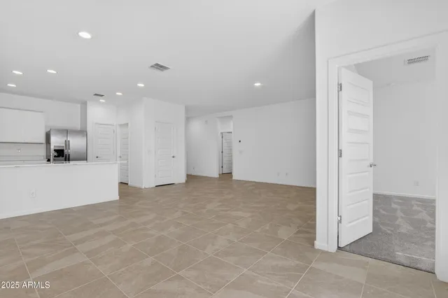 a view of kitchen with kitchen island and stainless steel appliances