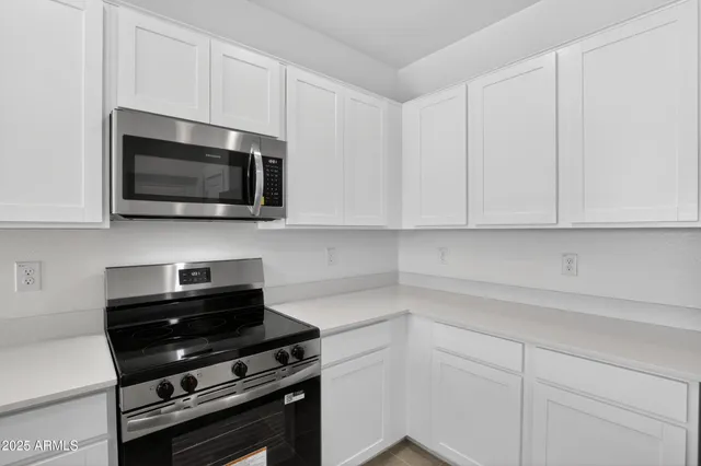 a kitchen with a microwave and cabinets