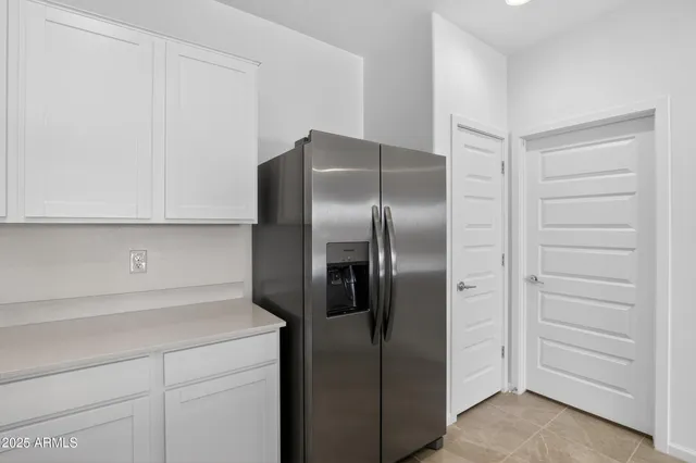 a kitchen with a refrigerator and cabinet