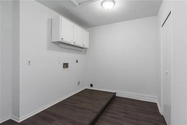 a view of a kitchen with wooden floor and cabinets