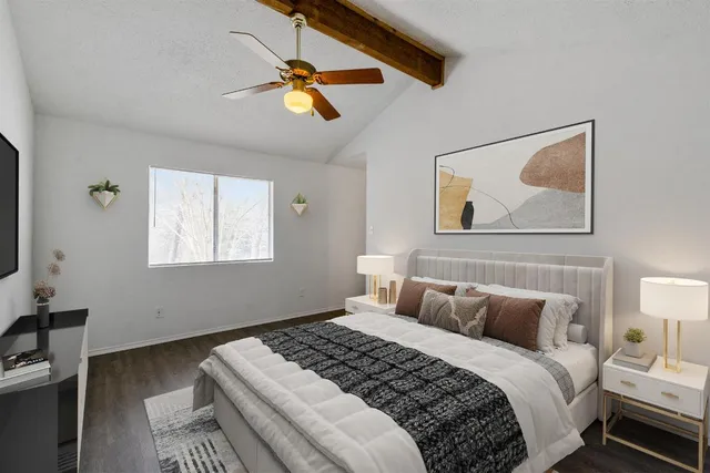 a bedroom with a bed and a painting on the wall