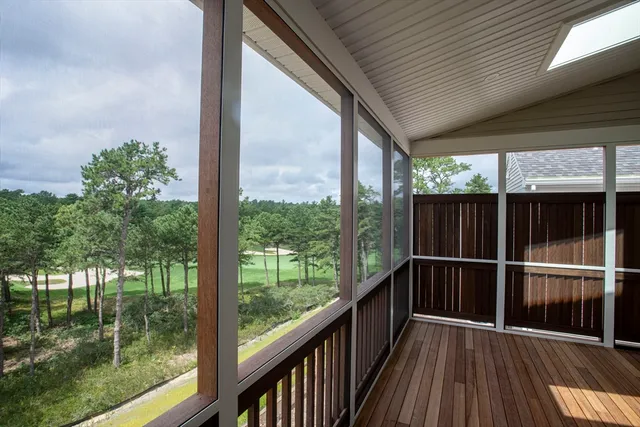 a view of a balcony with wooden floor