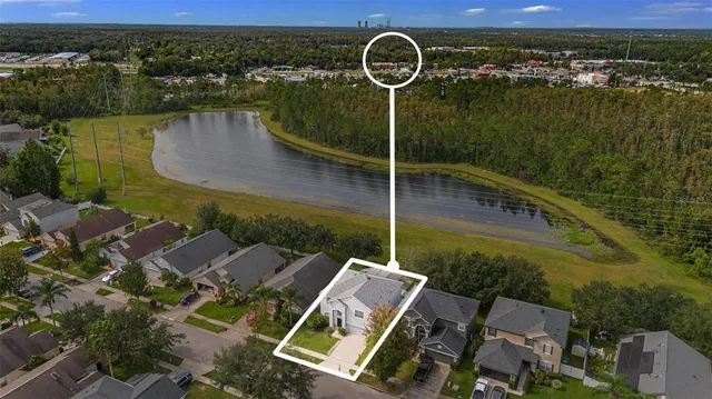 an aerial view of a house with a lake view