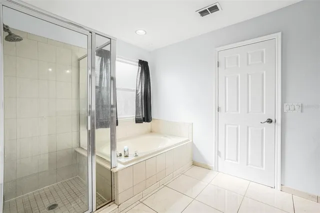 a bathroom with a tub and shower