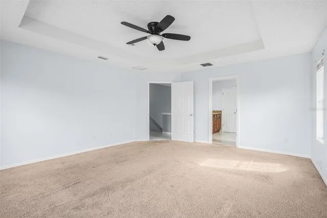 a view of a livingroom with a ceiling fan and window