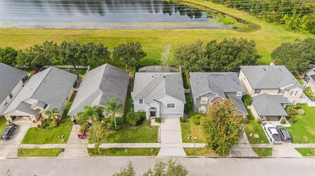 an aerial view of residential houses with outdoor space and swimming pool