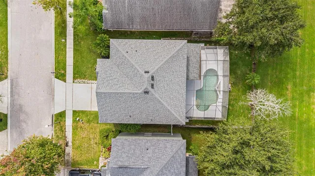an aerial view of a house with a yard