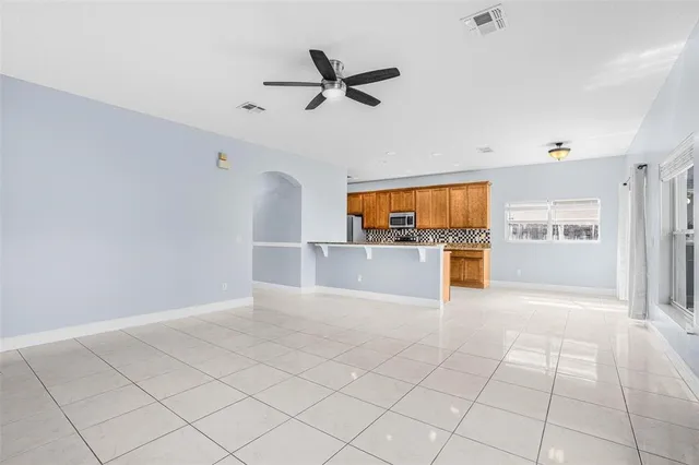 a view of a kitchen with a sink and a refrigerator