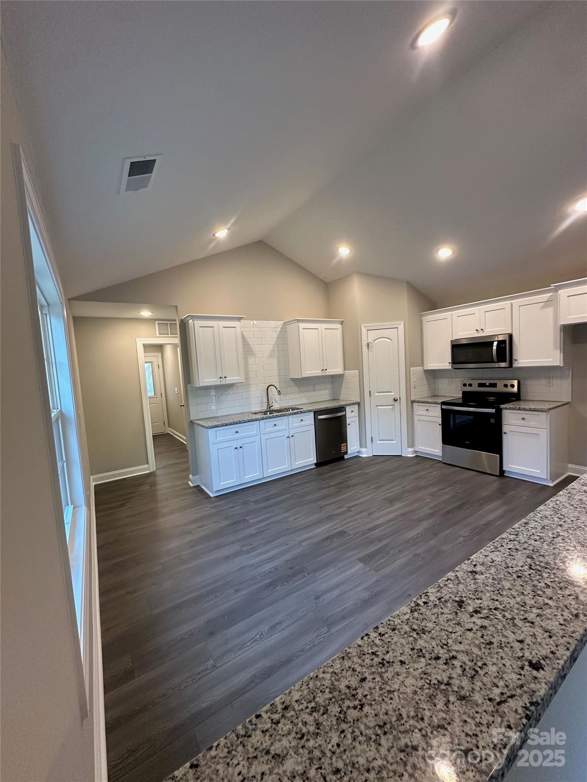 84 Highland Avenue Southwest Concord, NC 28027 - Photo 3 of 7 a view of kitchen and wooden floor