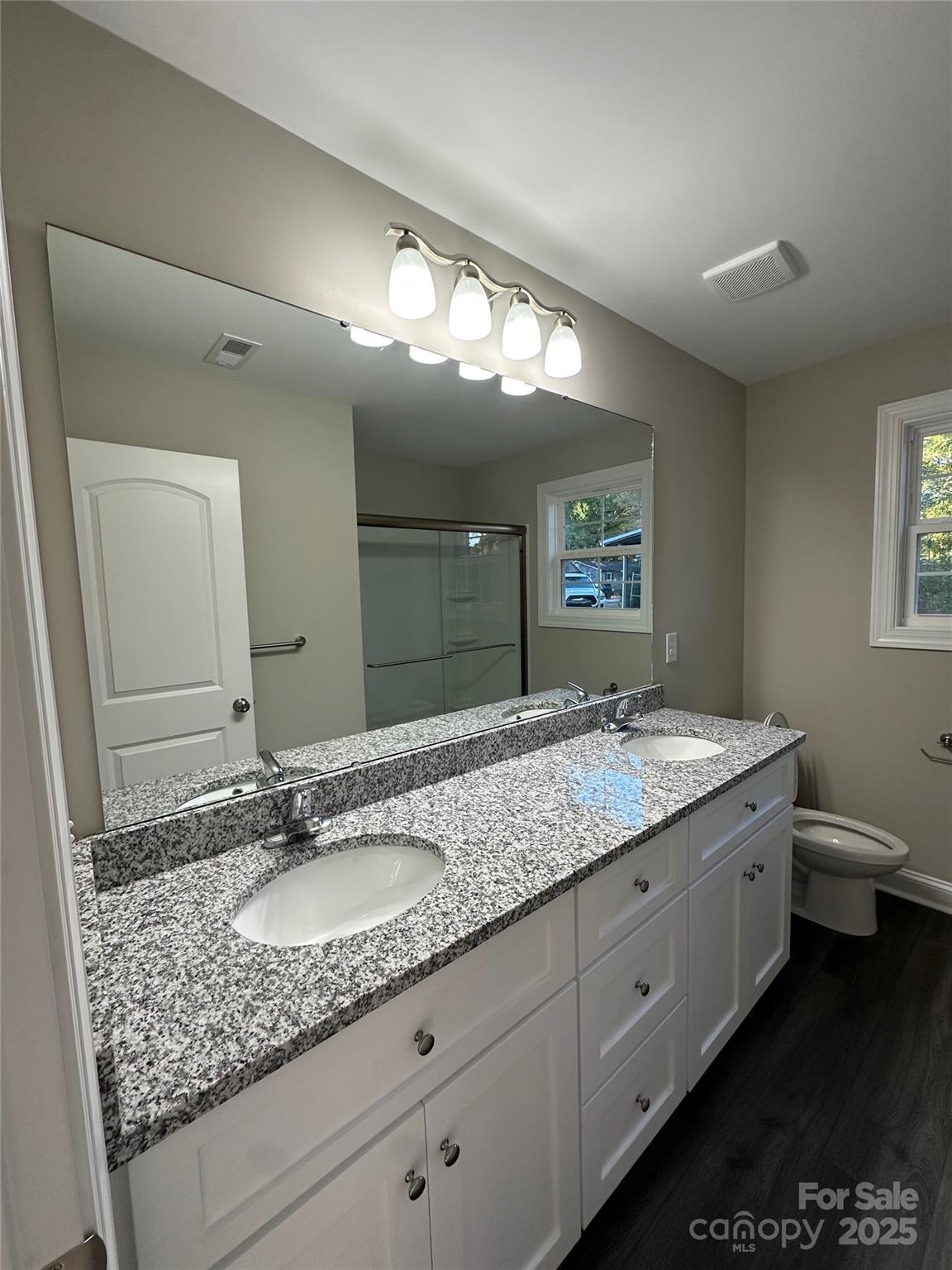 84 Highland Avenue Southwest Concord, NC 28027 - Photo 6 of 7 a bathroom with a granite countertop sink and a mirror