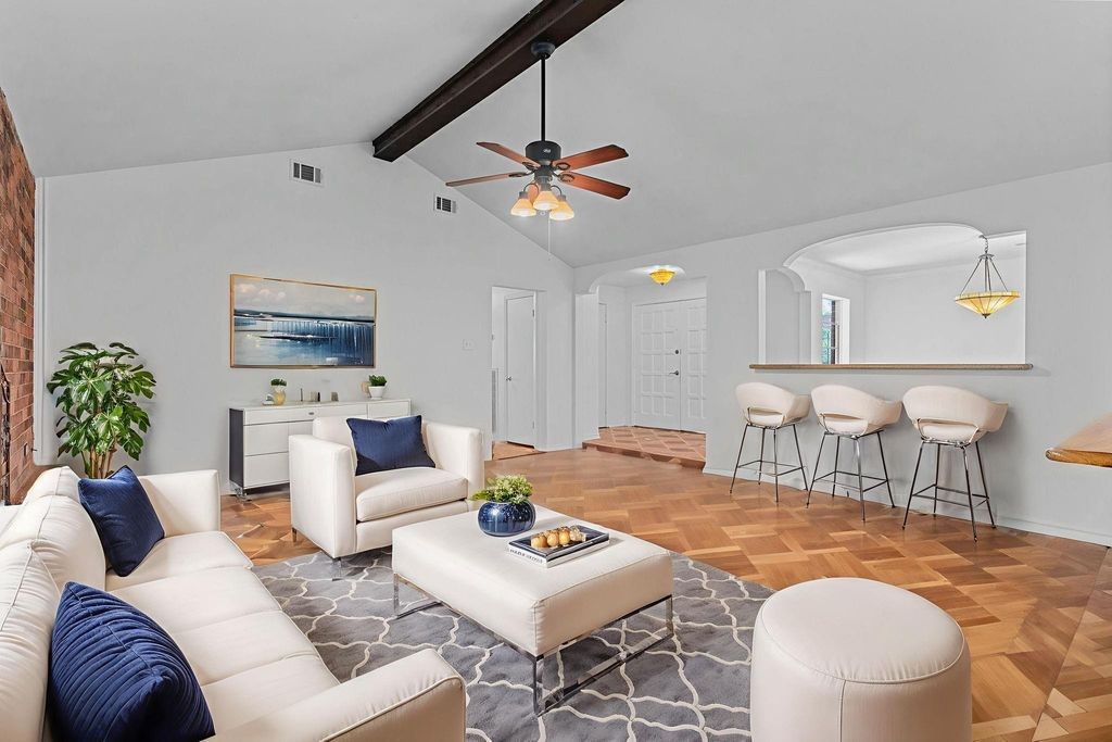 8918 Grape Street Houston, TX 77036 - Photo 12 of 40 a living room with furniture a rug and a chandelier