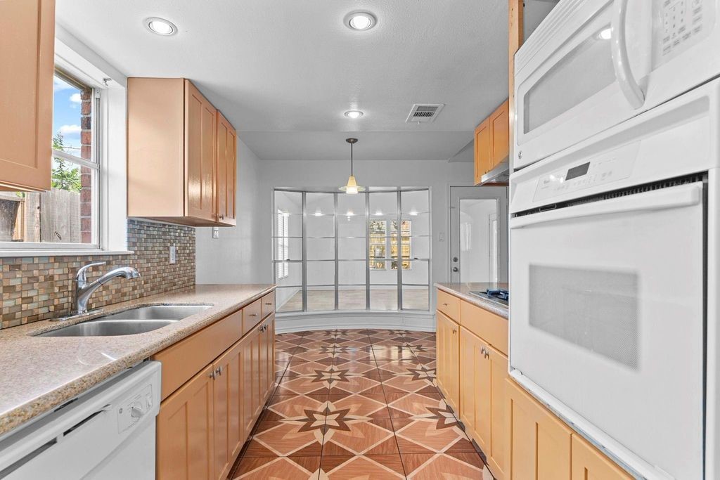8918 Grape Street Houston, TX 77036 - Photo 23 of 40 a bathroom with a sink a mirror and a shower