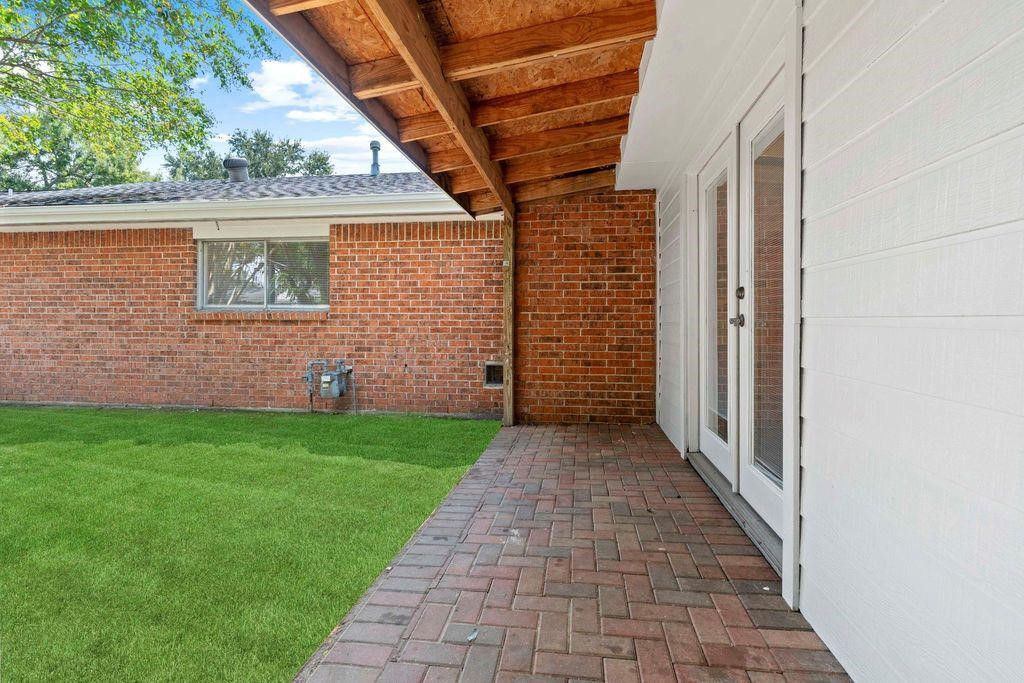 8918 Grape Street Houston, TX 77036 - Photo 27 of 40 a view of a brick house that has a small yard