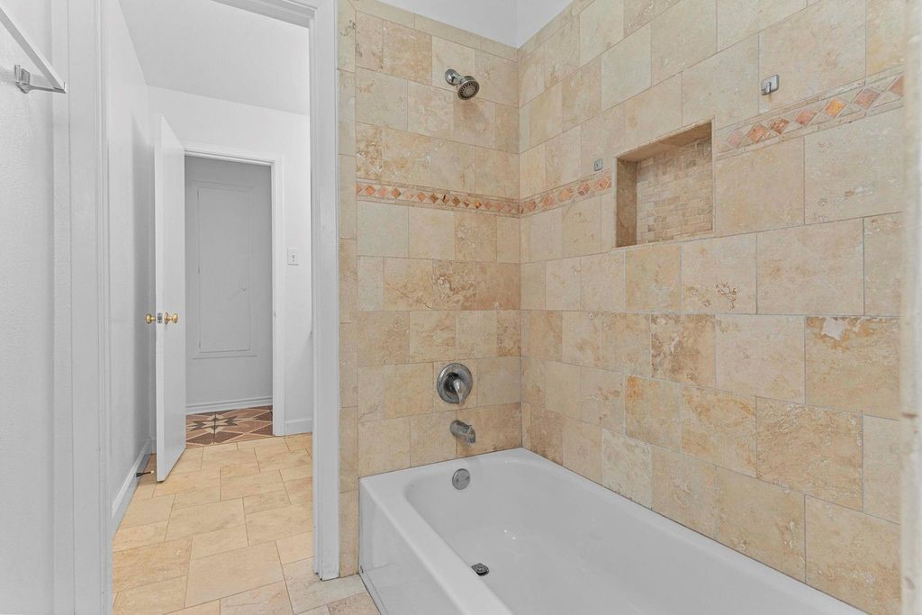 8918 Grape Street Houston, TX 77036 - Photo 35 of 40 a bathroom with a bathtub and a shower
