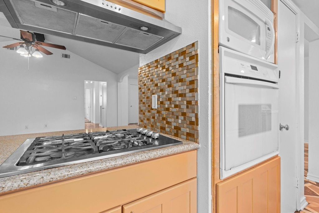 8918 Grape Street Houston, TX 77036 - Photo 8 of 40 a bathroom with a granite countertop sink a mirror and shower