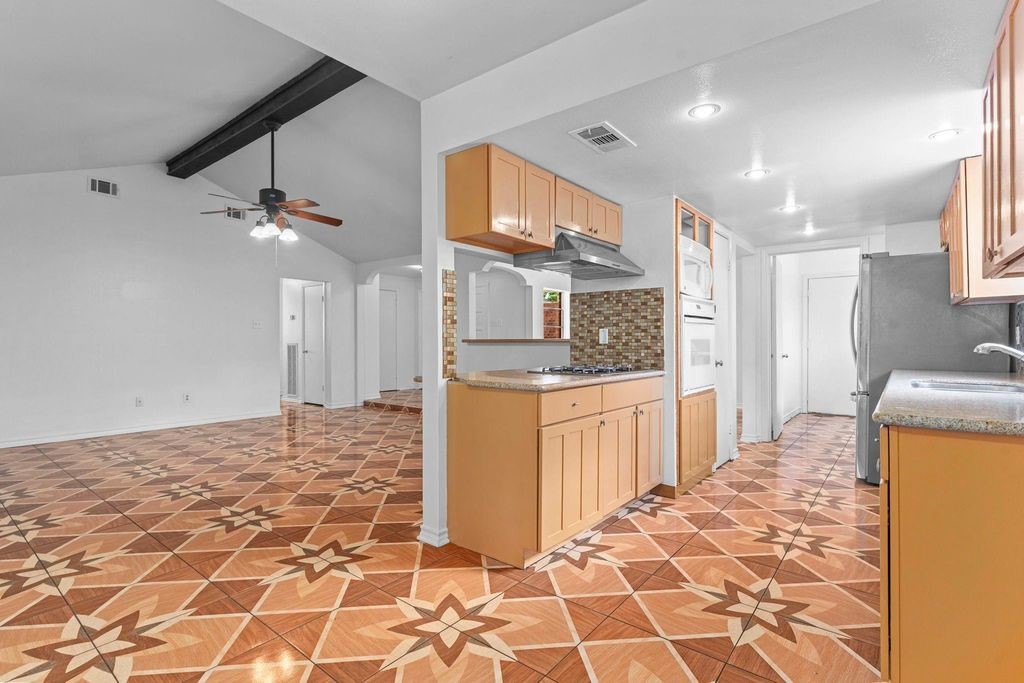 8918 Grape Street Houston, TX 77036 - Photo 9 of 40 a large bathroom with a granite countertop sink a mirror and shower