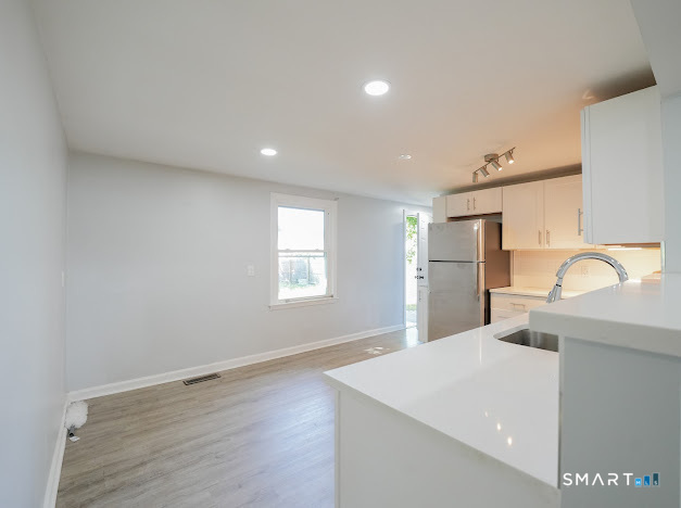 a view of a kitchen with a sink dishwasher and microwave