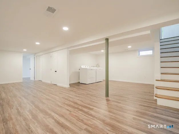 a view of a room with wooden floor and bathroom