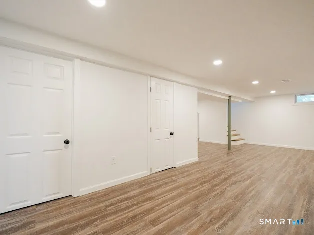 a view of an empty room with wooden floor