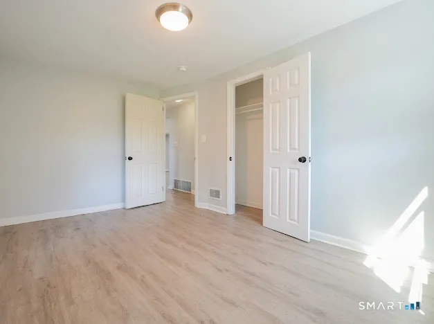 a view of an empty room and wooden floor