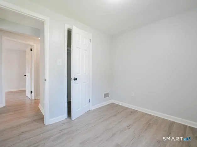 a view of a room with wooden floor