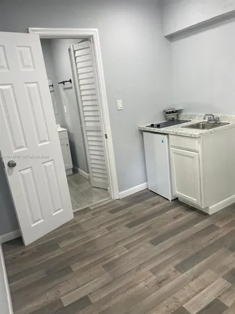a view of a kitchen from a wooden floor