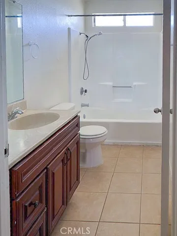 a view of hallway with a window and a refrigerator