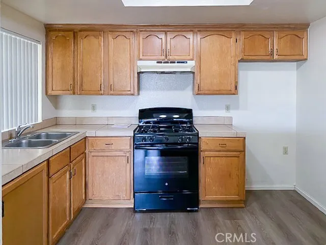a view of a room with wooden floor and window