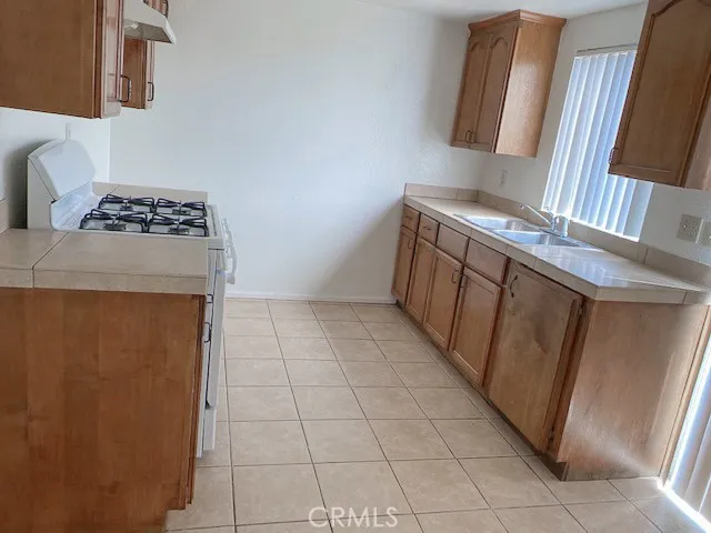 a bathroom with a granite countertop sink mirror vanity and toilet