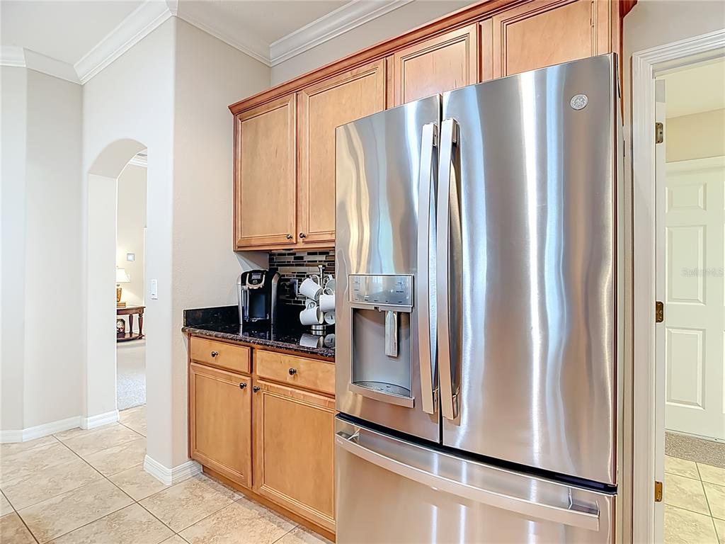 277 Magneta Loop Auburndale, FL 33823 - Photo 12 of 58 a kitchen with stainless steel appliances granite countertop a refrigerator and a stove