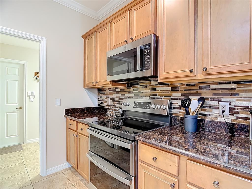 277 Magneta Loop Auburndale, FL 33823 - Photo 14 of 58 a kitchen with a stove and a microwave