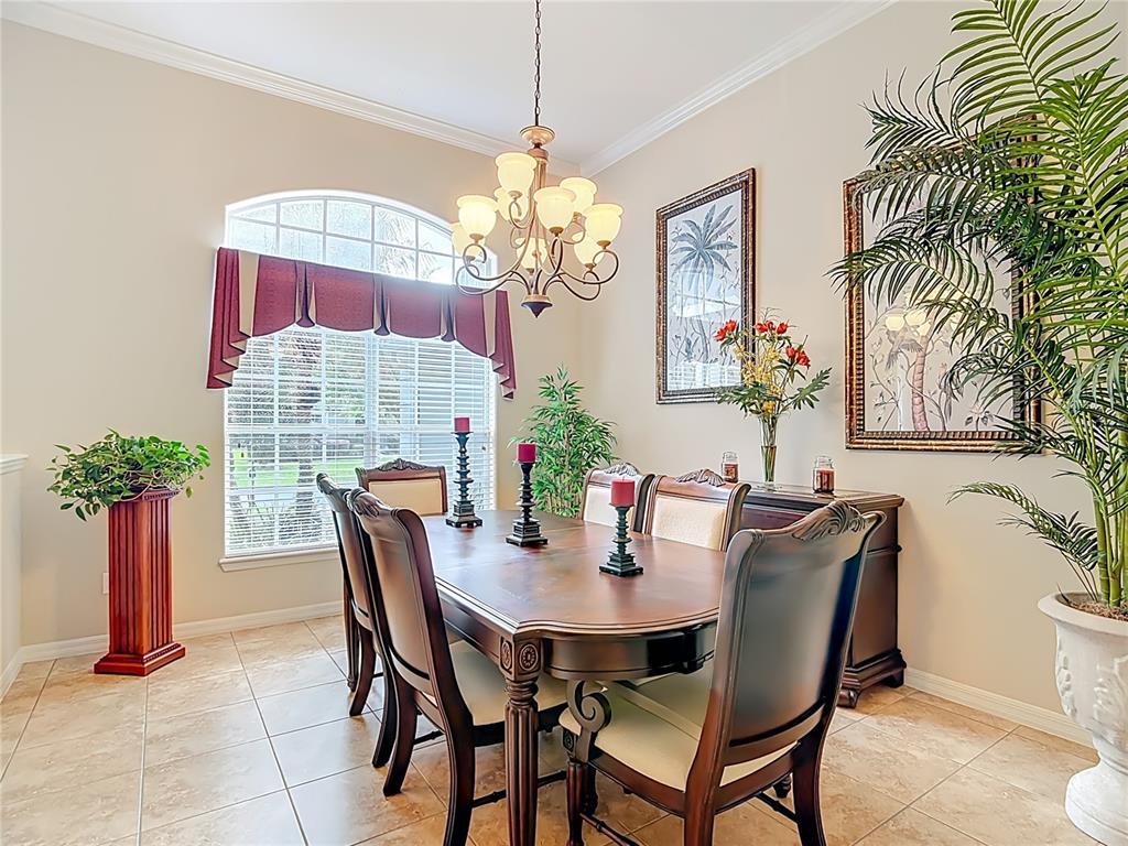 277 Magneta Loop Auburndale, FL 33823 - Photo 15 of 58 a view of a dining room with furniture and a chandelier
