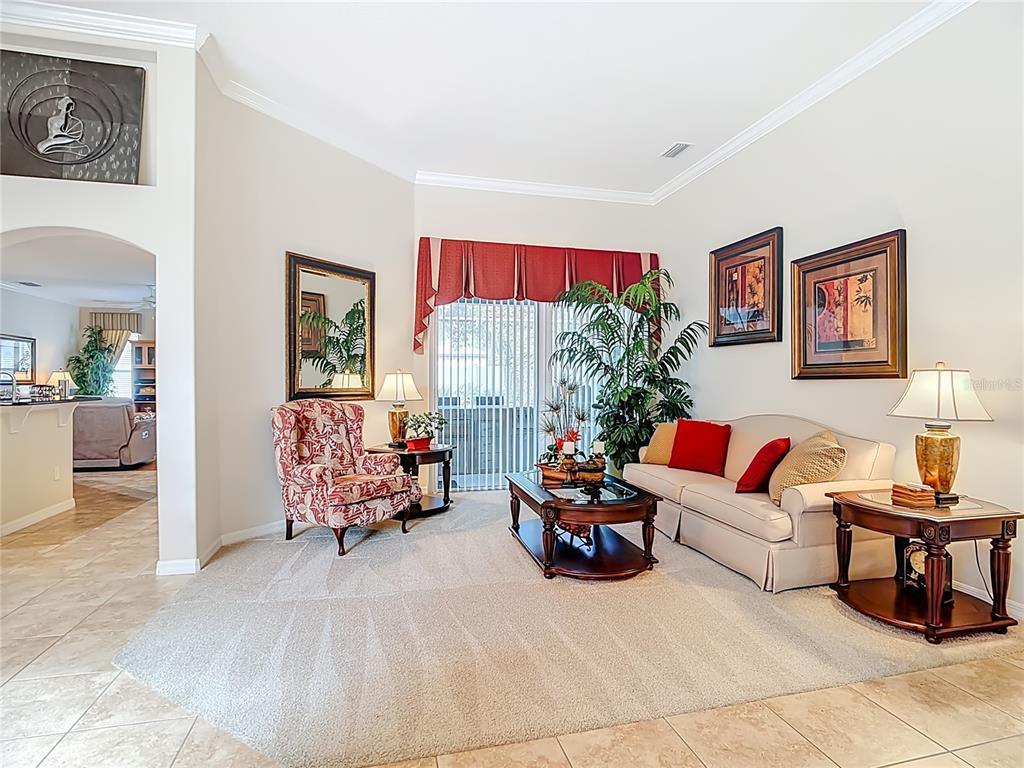 277 Magneta Loop Auburndale, FL 33823 - Photo 18 of 58 a living room with furniture and a floor to ceiling window