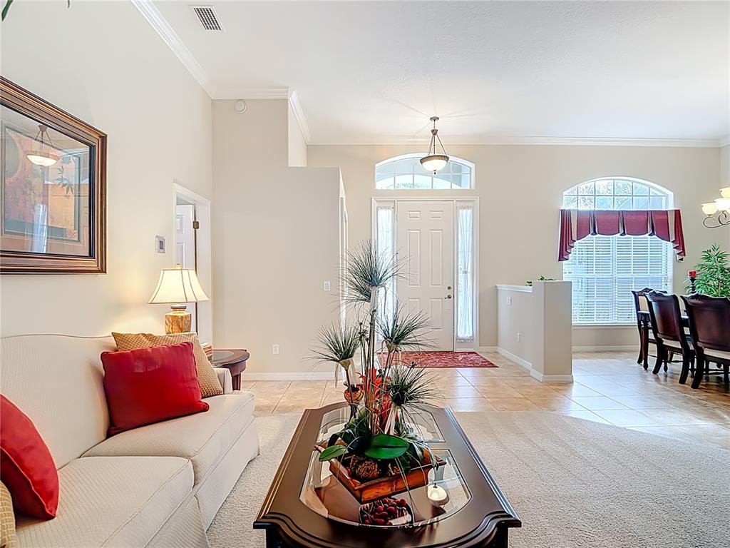 277 Magneta Loop Auburndale, FL 33823 - Photo 20 of 58 a living room with furniture chandelier and a table