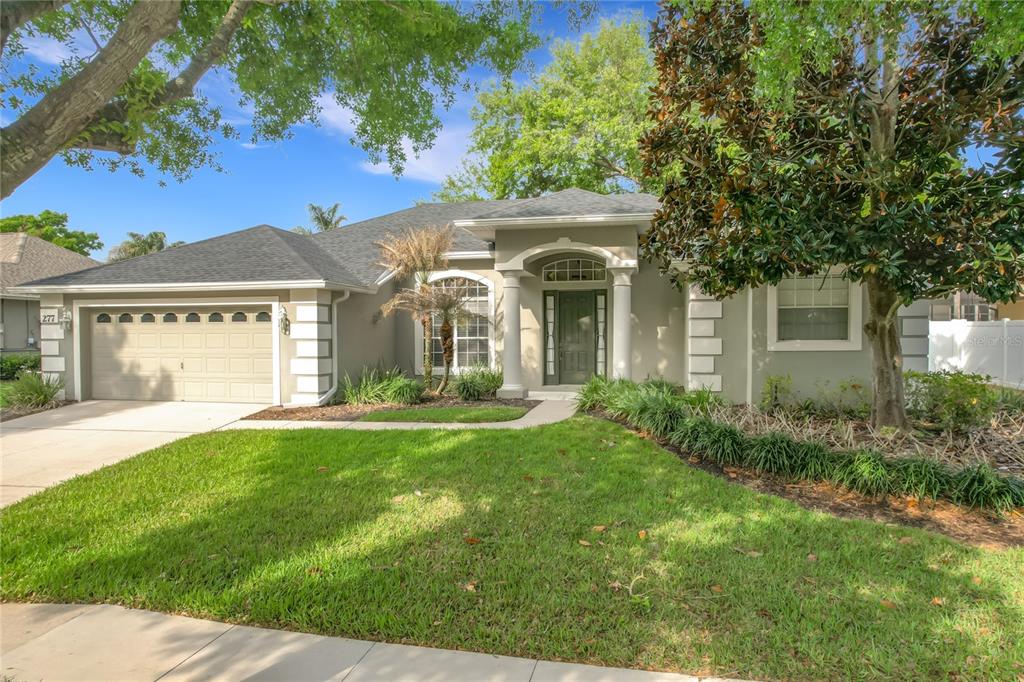 277 Magneta Loop Auburndale, FL 33823 - Photo 2 of 58 a front view of a house with a garden