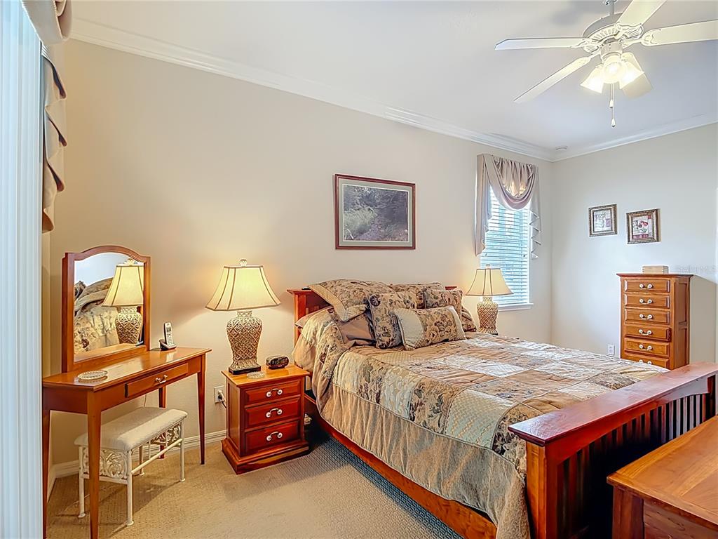 277 Magneta Loop Auburndale, FL 33823 - Photo 22 of 58 a bedroom with a bed and a lamp on dresser