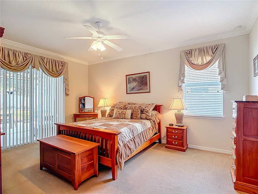 277 Magneta Loop Auburndale, FL 33823 - Photo 23 of 58 a bedroom with a bed and a chandelier