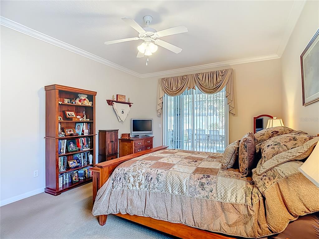 277 Magneta Loop Auburndale, FL 33823 - Photo 25 of 58 a bedroom with a bed furniture and a large window